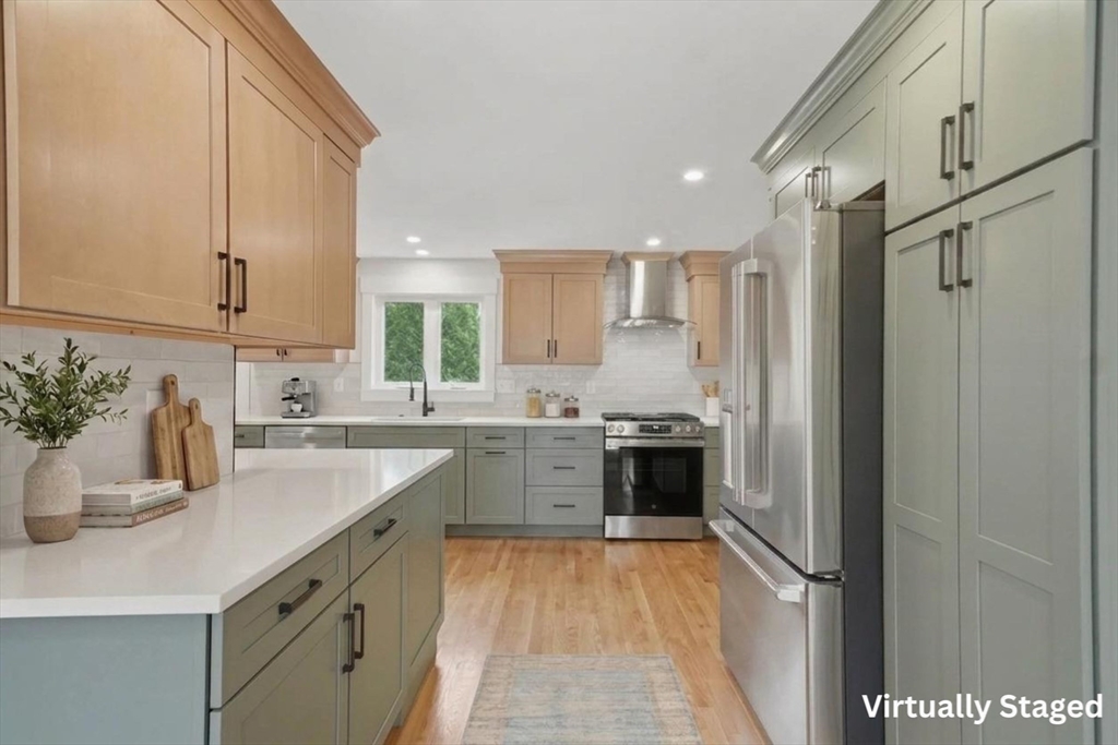 105 Stafford Road Lowell, MA 01852 - Photo 11 of 42 a kitchen with a sink refrigerator and cabinets