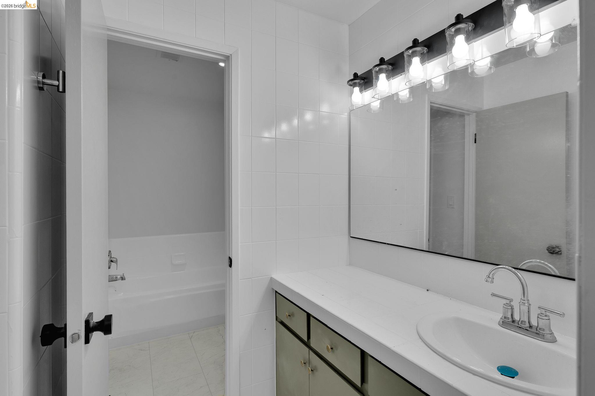 1808 Wildbrook Court, Unit D Concord, CA 94521 - Photo 37 of 47 a bathroom with a sink and a mirror