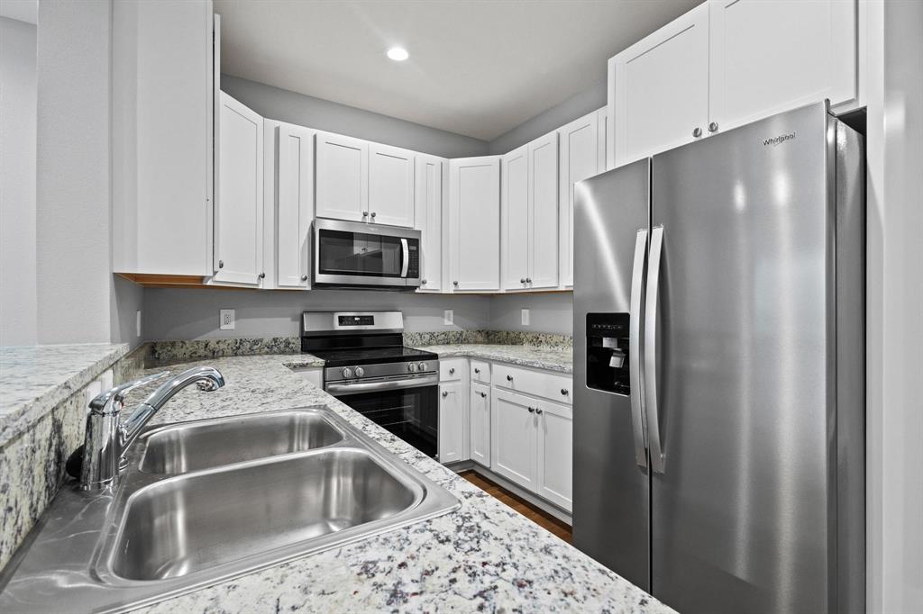 724 West Gandy Street Denison, TX 75020 - Photo 12 of 31 a kitchen with stainless steel appliances a refrigerator sink and microwave