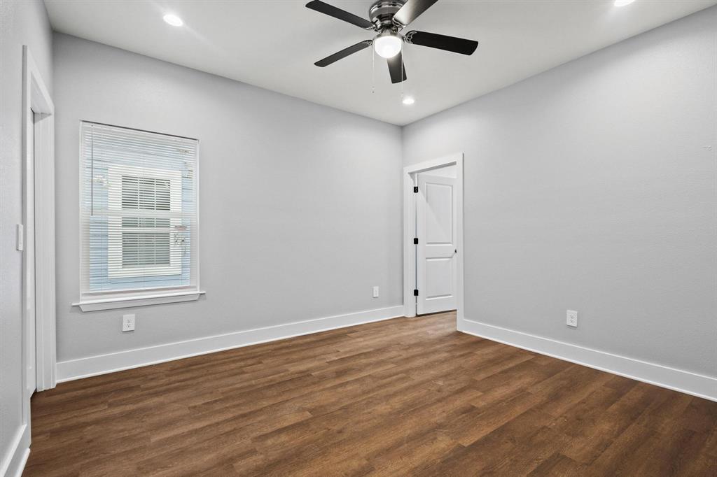 724 West Gandy Street Denison, TX 75020 - Photo 16 of 31 an empty room with wooden floor fan and windows