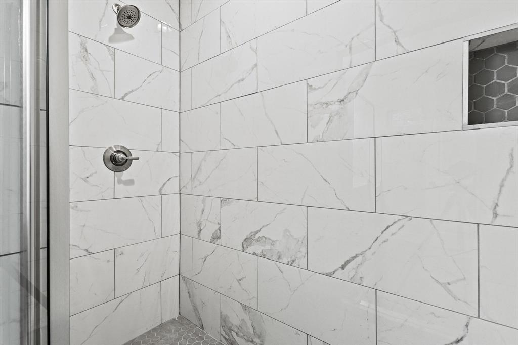 724 West Gandy Street Denison, TX 75020 - Photo 21 of 31 a bathroom with a shower