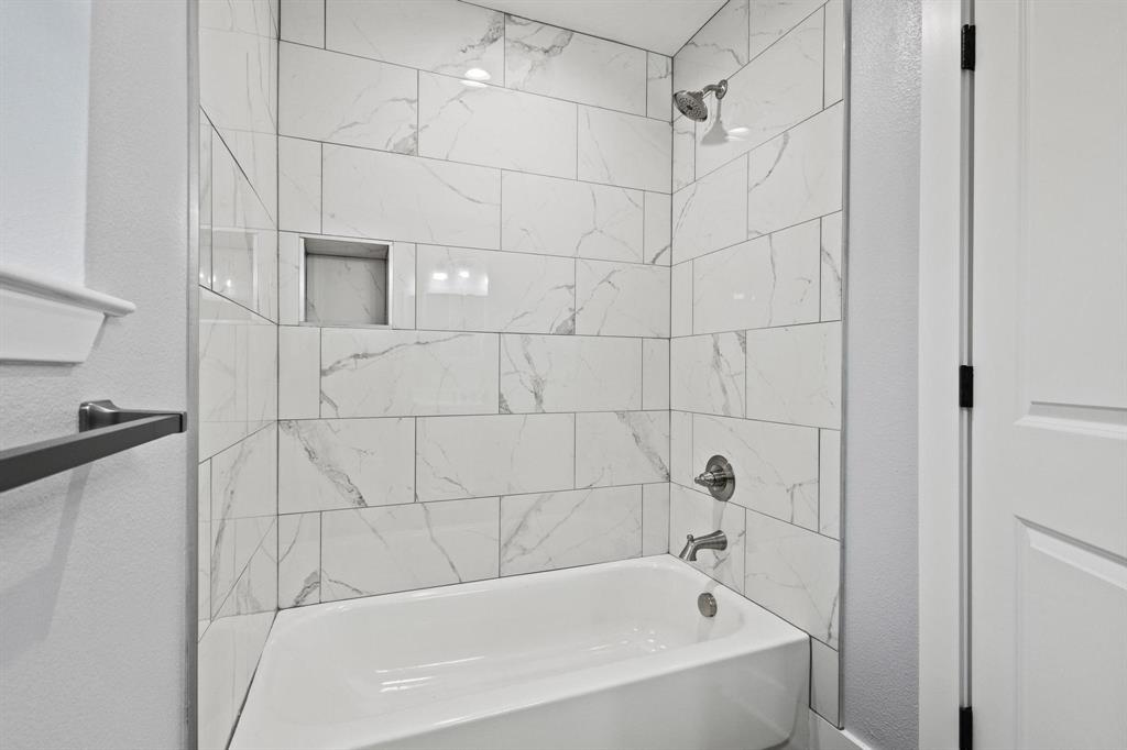 724 West Gandy Street Denison, TX 75020 - Photo 27 of 31 a bathroom with a bathtub