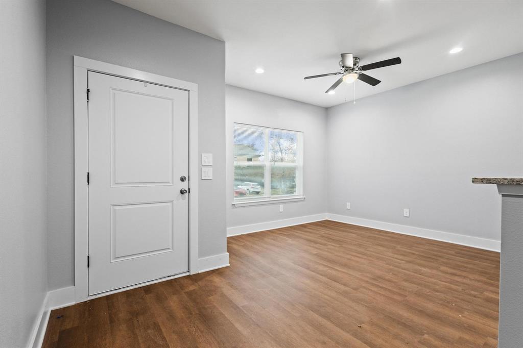 724 West Gandy Street Denison, TX 75020 - Photo 5 of 31 a view of an empty room with wooden floor and a window
