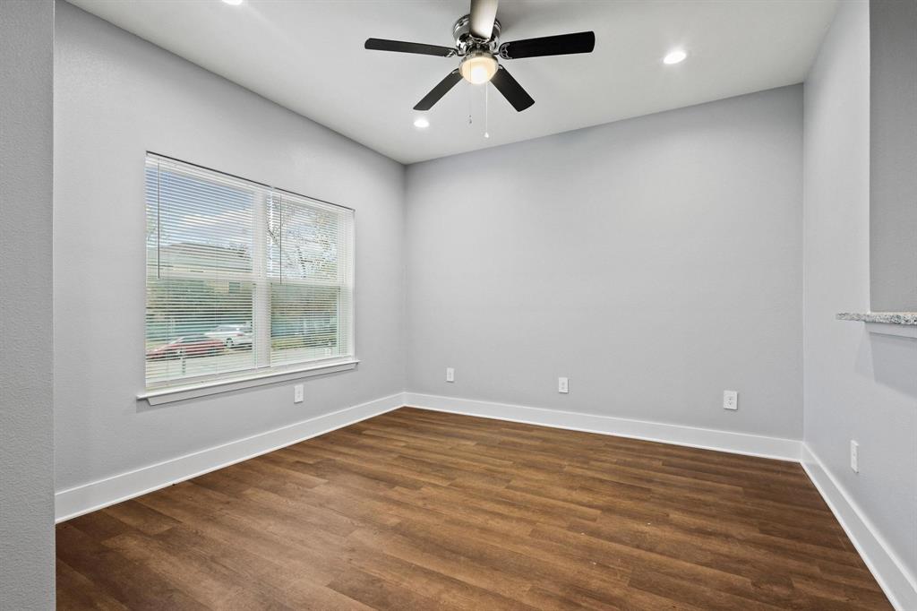 724 West Gandy Street Denison, TX 75020 - Photo 6 of 31 an empty room with a window and a ceiling fan