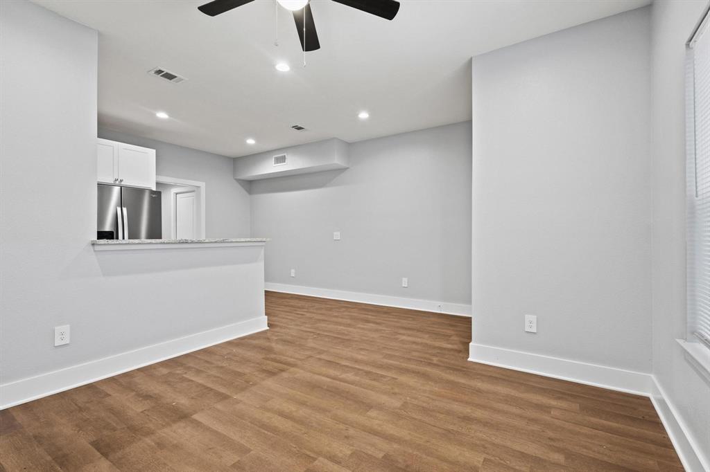 724 West Gandy Street Denison, TX 75020 - Photo 7 of 31 wooden floor in an empty room with a window