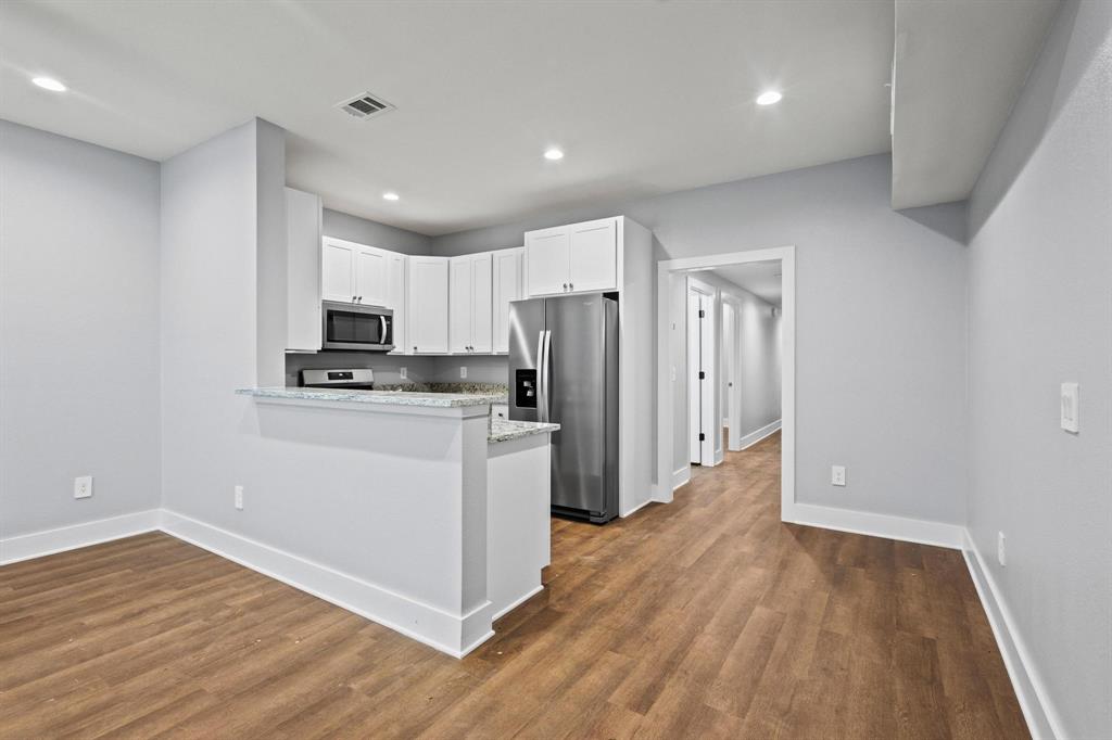 724 West Gandy Street Denison, TX 75020 - Photo 9 of 31 a kitchen with white cabinets and stainless steel appliances