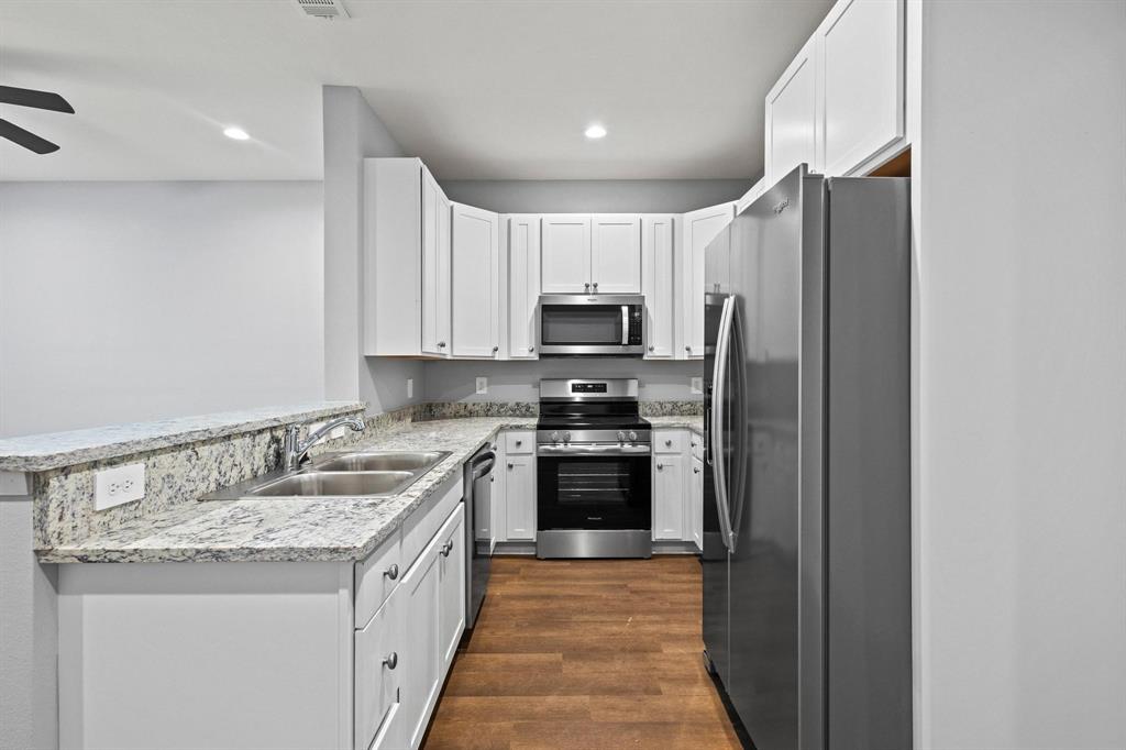 724 West Gandy Street Denison, TX 75020 - Photo 10 of 31 a kitchen with stainless steel appliances granite countertop a refrigerator and a stove top oven