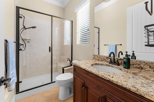 a kitchen with stainless steel appliances kitchen island granite countertop a refrigerator a stove a kitchen island with a dining table and chairs