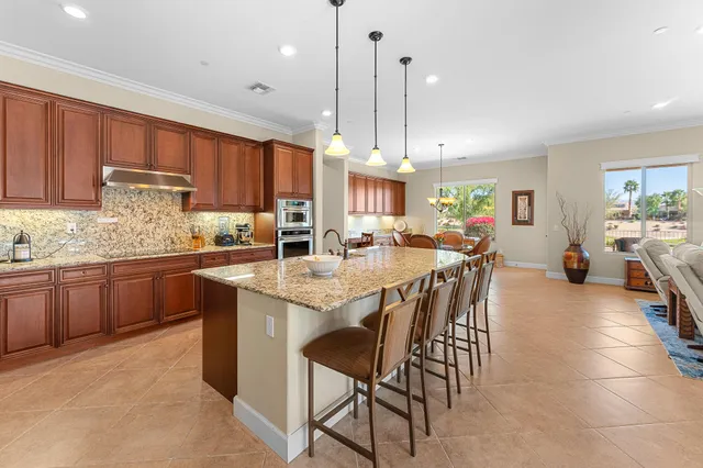 a view of a patio with lawn chairs floor to ceiling window and wooden floor