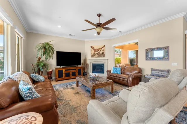a living room with furniture ceiling fan and a rug