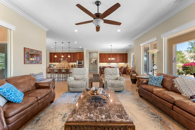 a bed sitting in a spacious bedroom next to a window