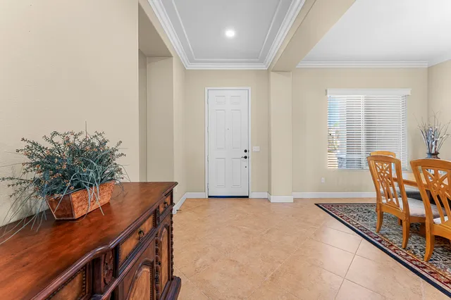 a dining room with furniture a rug and wooden floor