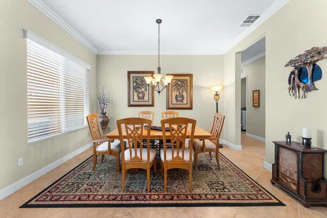 a view of a hallway with wooden floor and a livingroom