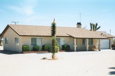 6460 Maricopa Road Phelan, CA 92371 - Photo 1 of 1 a front view of a house with a yard