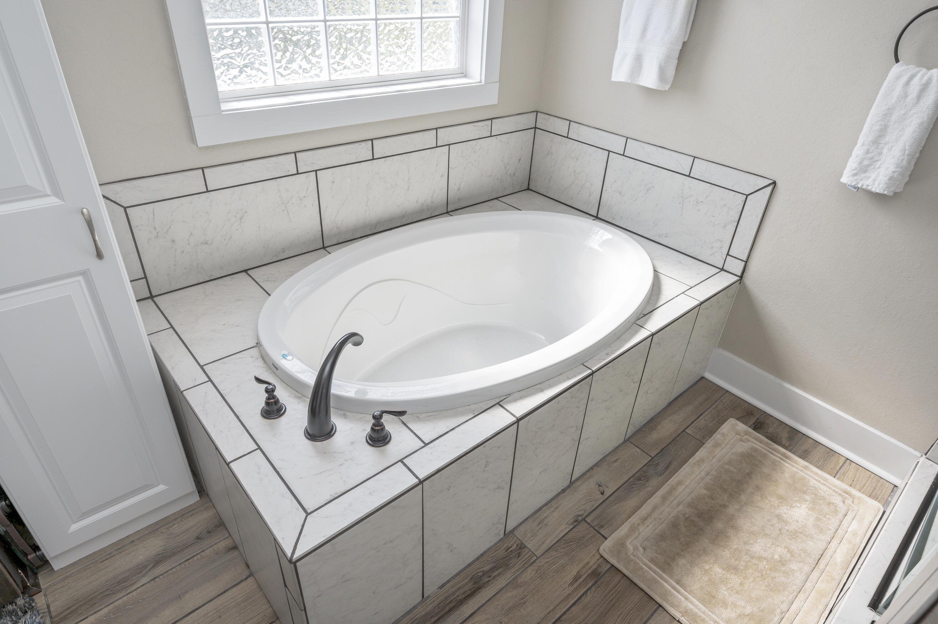 3960 Painter Branch Road Crestview, FL 32539 - Photo 20 of 46 a white bath tub sitting in a bathroom next to a window