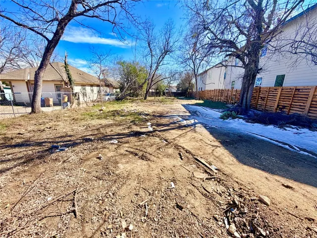 a view of yard with wooden fence
