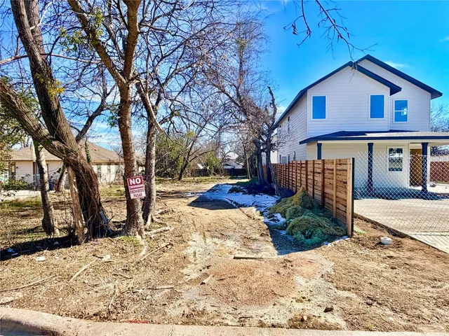 a view of a house with snow on the road