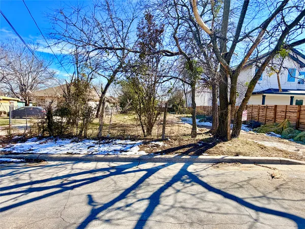 a view of a yard with snow on the road