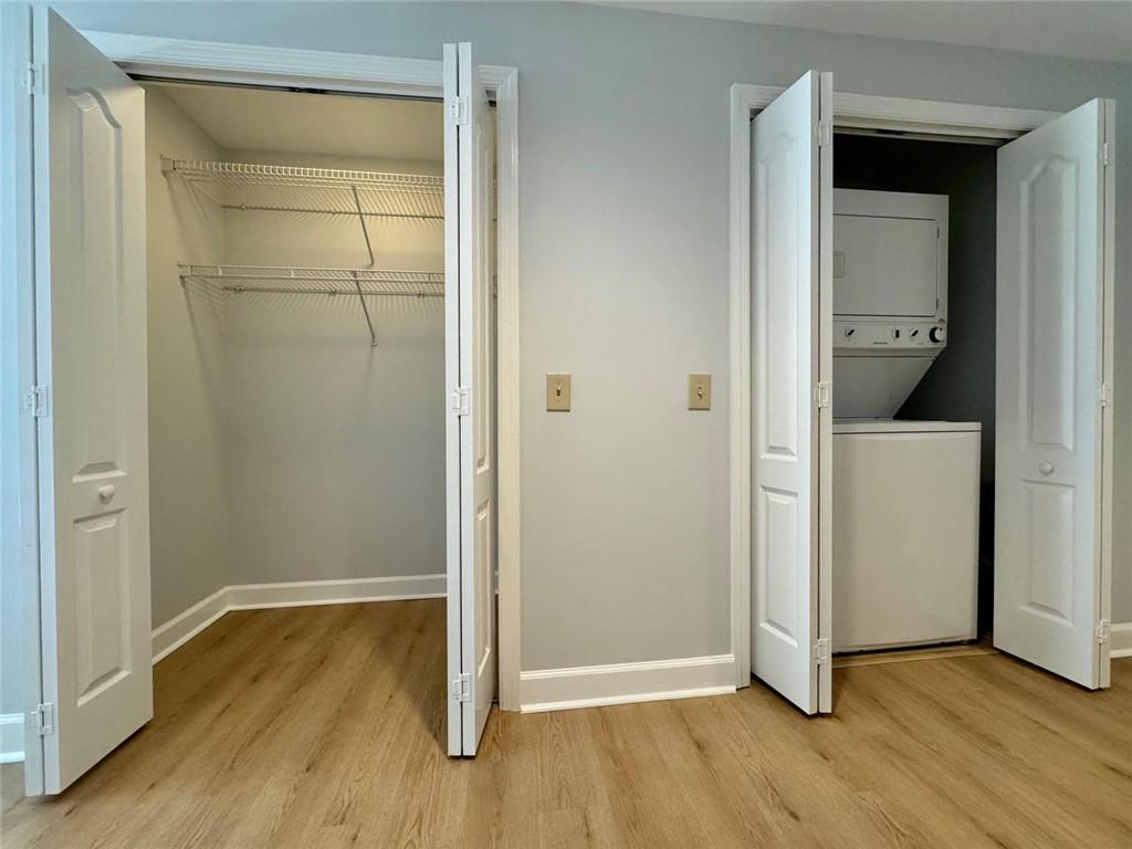 195 14th Street Northeast, Unit 1501 Atlanta, GA 30309 - Photo 12 of 47 a view of an empty room with wooden floor and a hallway