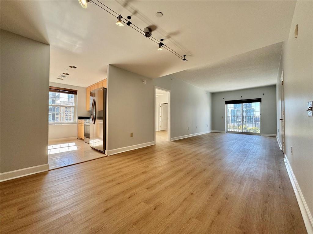 195 14th Street Northeast, Unit 1501 Atlanta, GA 30309 - Photo 14 of 47 a view of an empty room with window and wooden floor