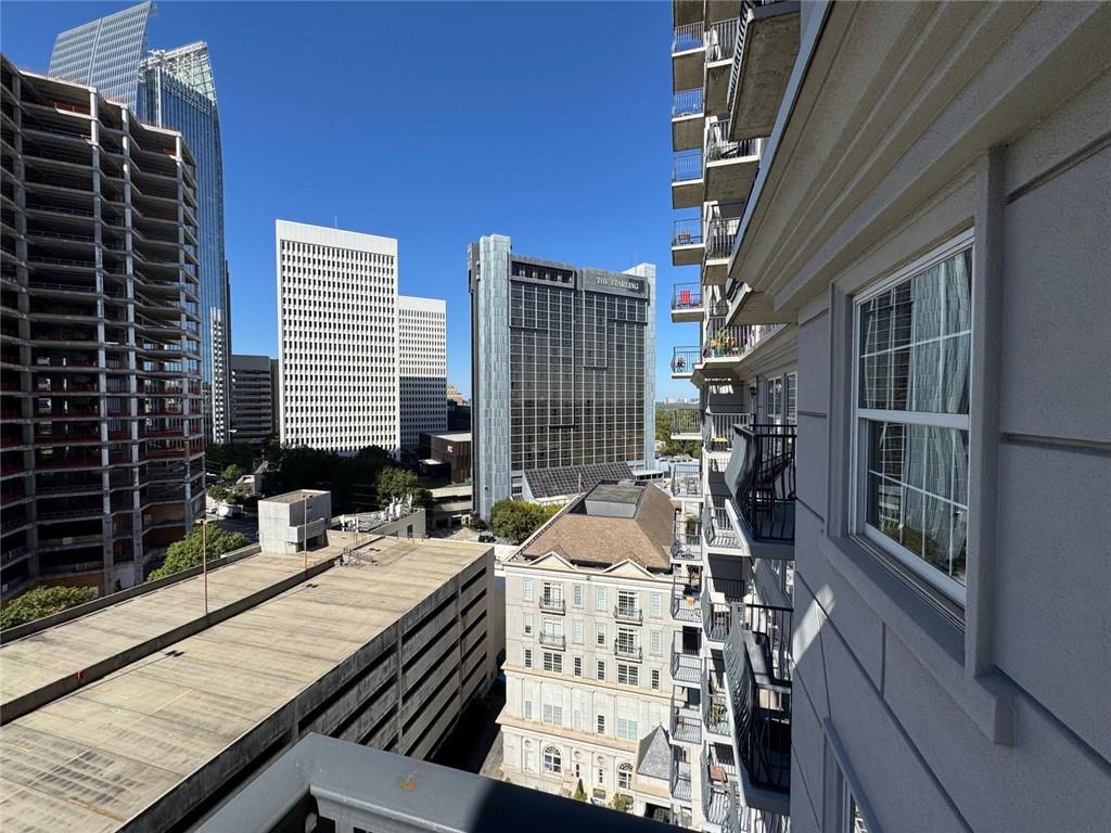 195 14th Street Northeast, Unit 1501 Atlanta, GA 30309 - Photo 19 of 47 a balcony with table and chairs