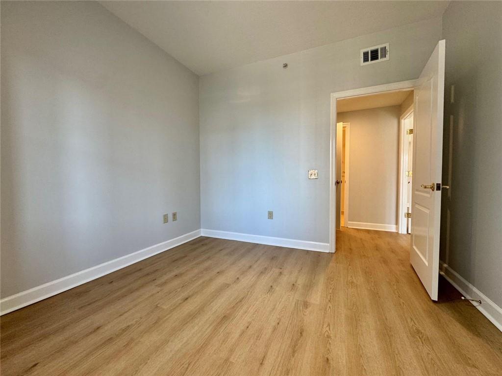 195 14th Street Northeast, Unit 1501 Atlanta, GA 30309 - Photo 28 of 47 a view of a room with wooden floor and a gate
