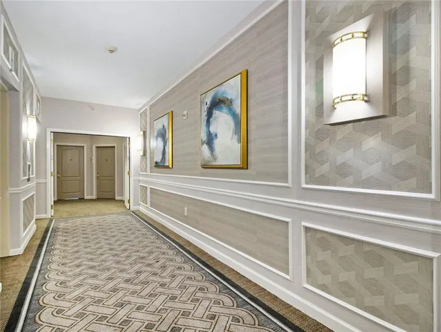 a kitchen with stainless steel appliances granite countertop a refrigerator a stove and a sink with wooden floor