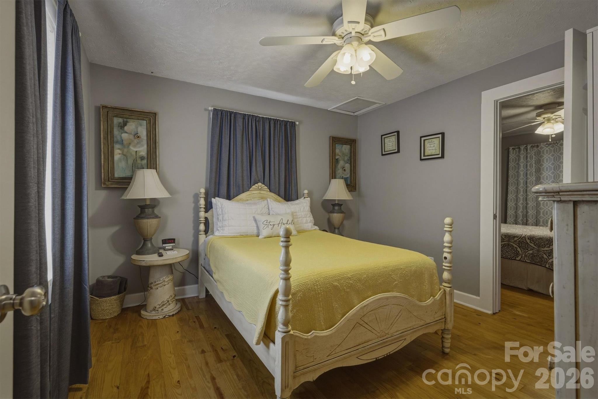905 Carbon City Road Morganton, NC 28655 - Photo 16 of 29 a bedroom with a bed and a chandelier