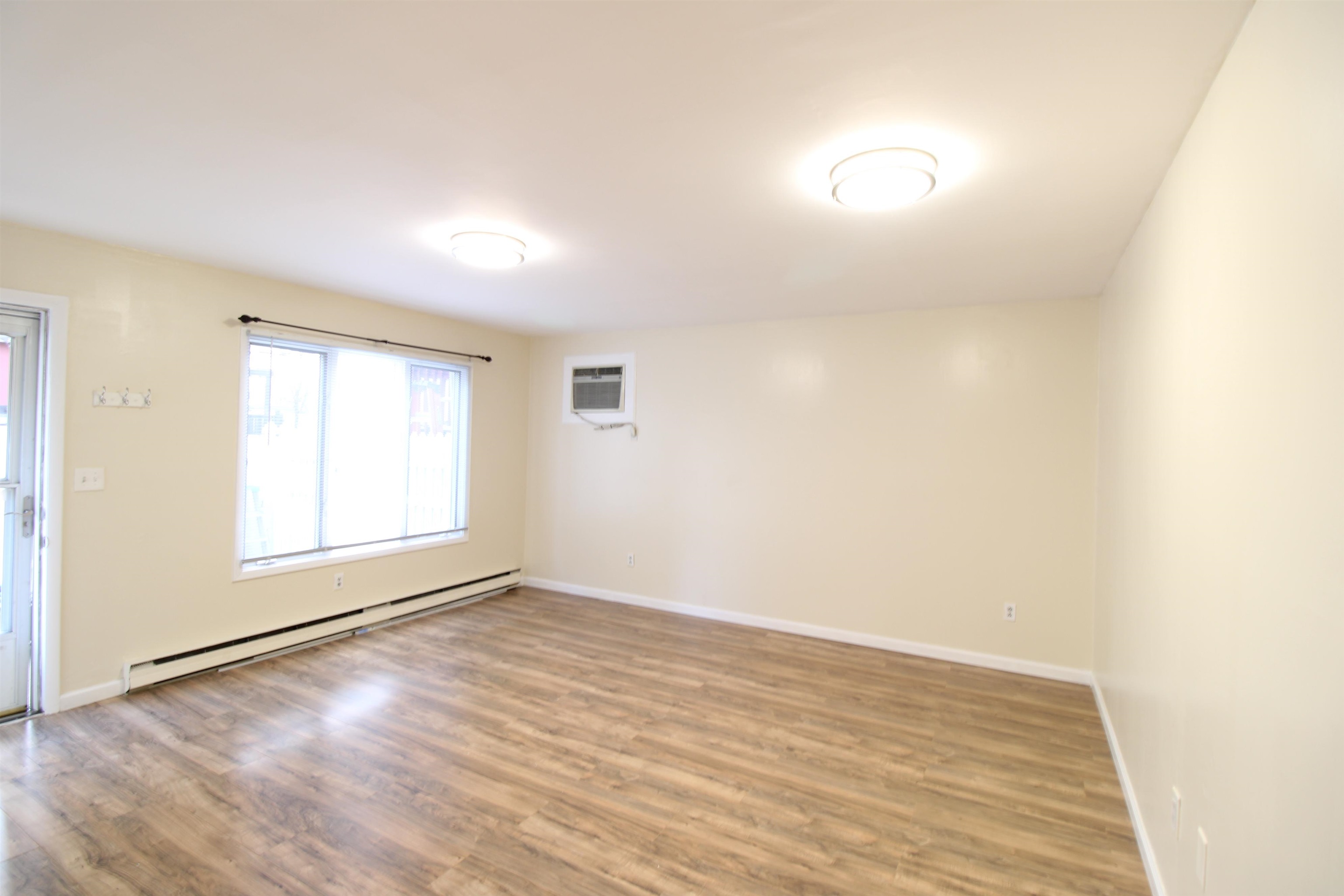 762 5th Street, Unit 1 Secaucus, NJ 07094 - Photo 4 of 27 an empty room with wooden floor and windows