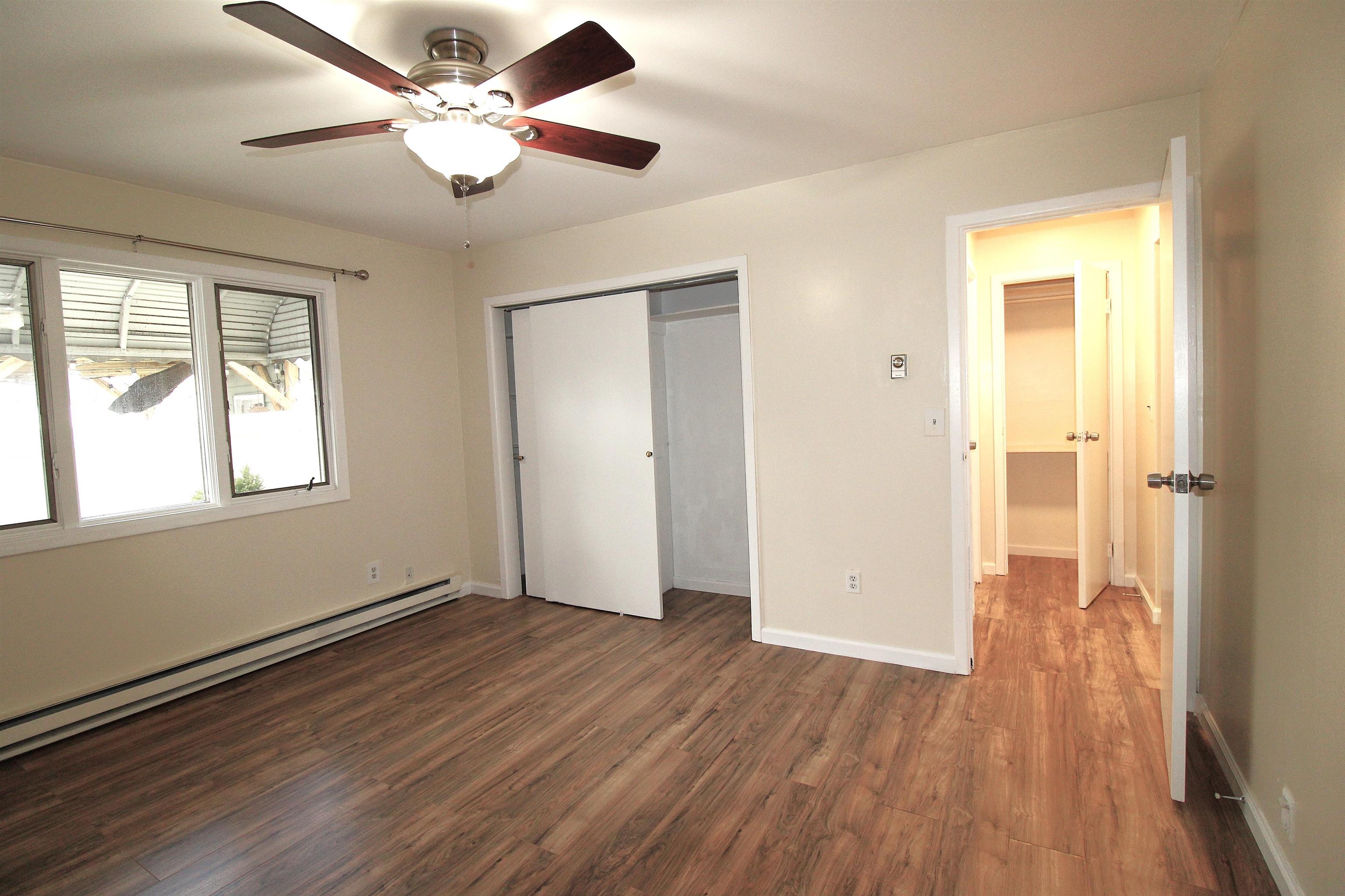 762 5th Street, Unit 1 Secaucus, NJ 07094 - Photo 6 of 27 an empty room with wooden floor and a ceiling fan