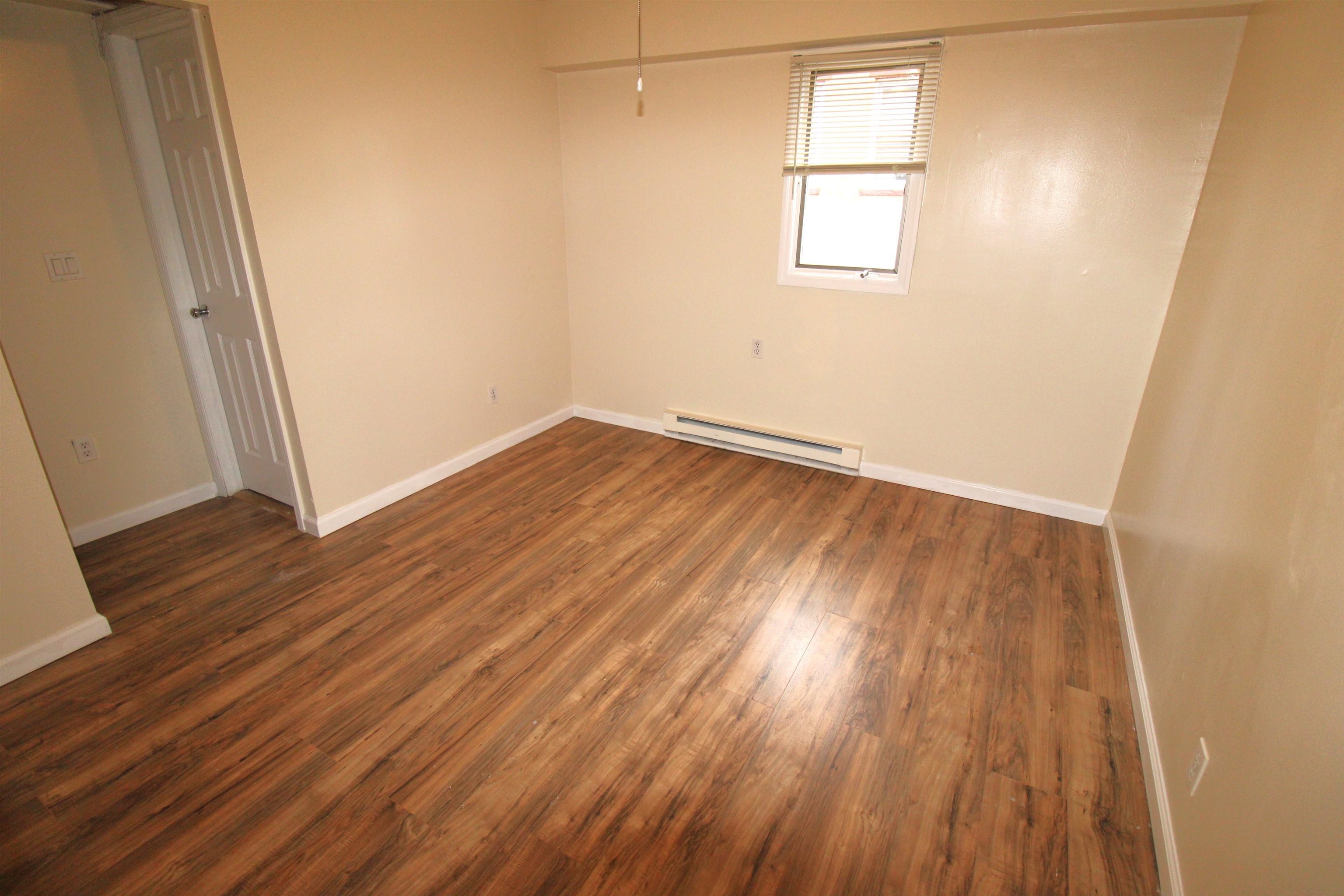 762 5th Street, Unit 1 Secaucus, NJ 07094 - Photo 8 of 27 an empty room with wooden floor and windows