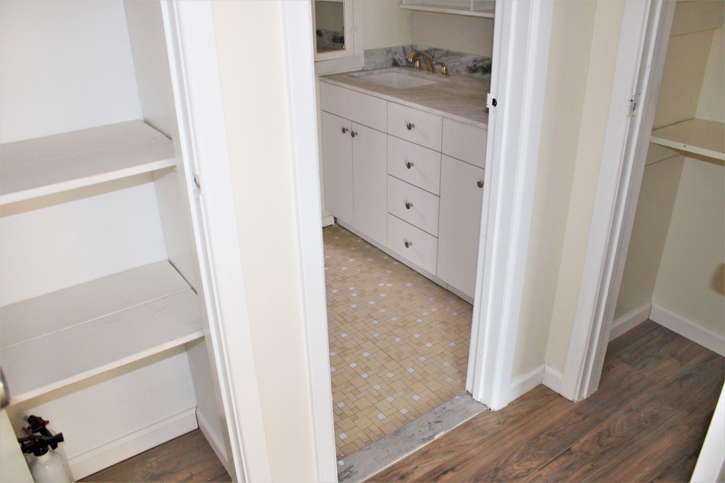 762 5th Street, Unit 1 Secaucus, NJ 07094 - Photo 10 of 27 a bathroom with a granite countertop sink and a mirror