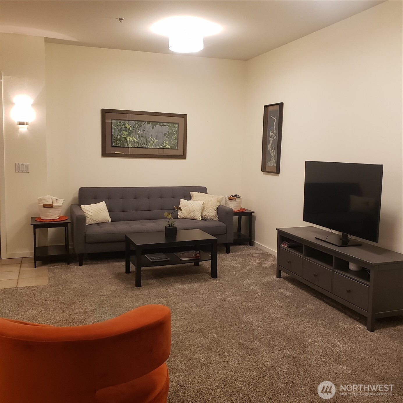 2000 Alaskan Way, Unit 342 Seattle, WA 98121 - Photo 12 of 40 a living room with furniture and a flat screen tv