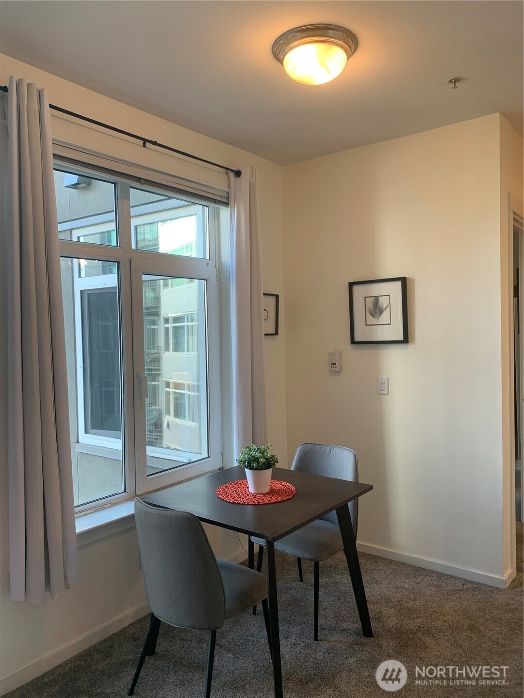 2000 Alaskan Way, Unit 342 Seattle, WA 98121 - Photo 17 of 40 a view of a dining room with furniture and a window