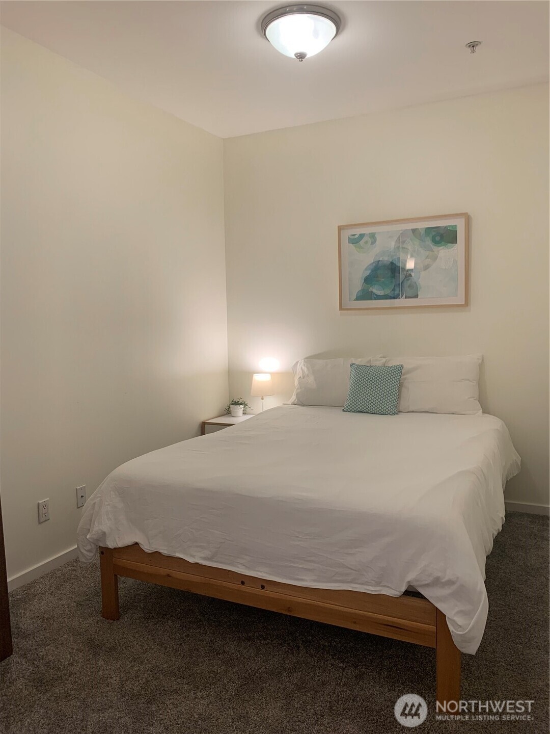 2000 Alaskan Way, Unit 342 Seattle, WA 98121 - Photo 25 of 40 a bedroom with a bed and a lamp