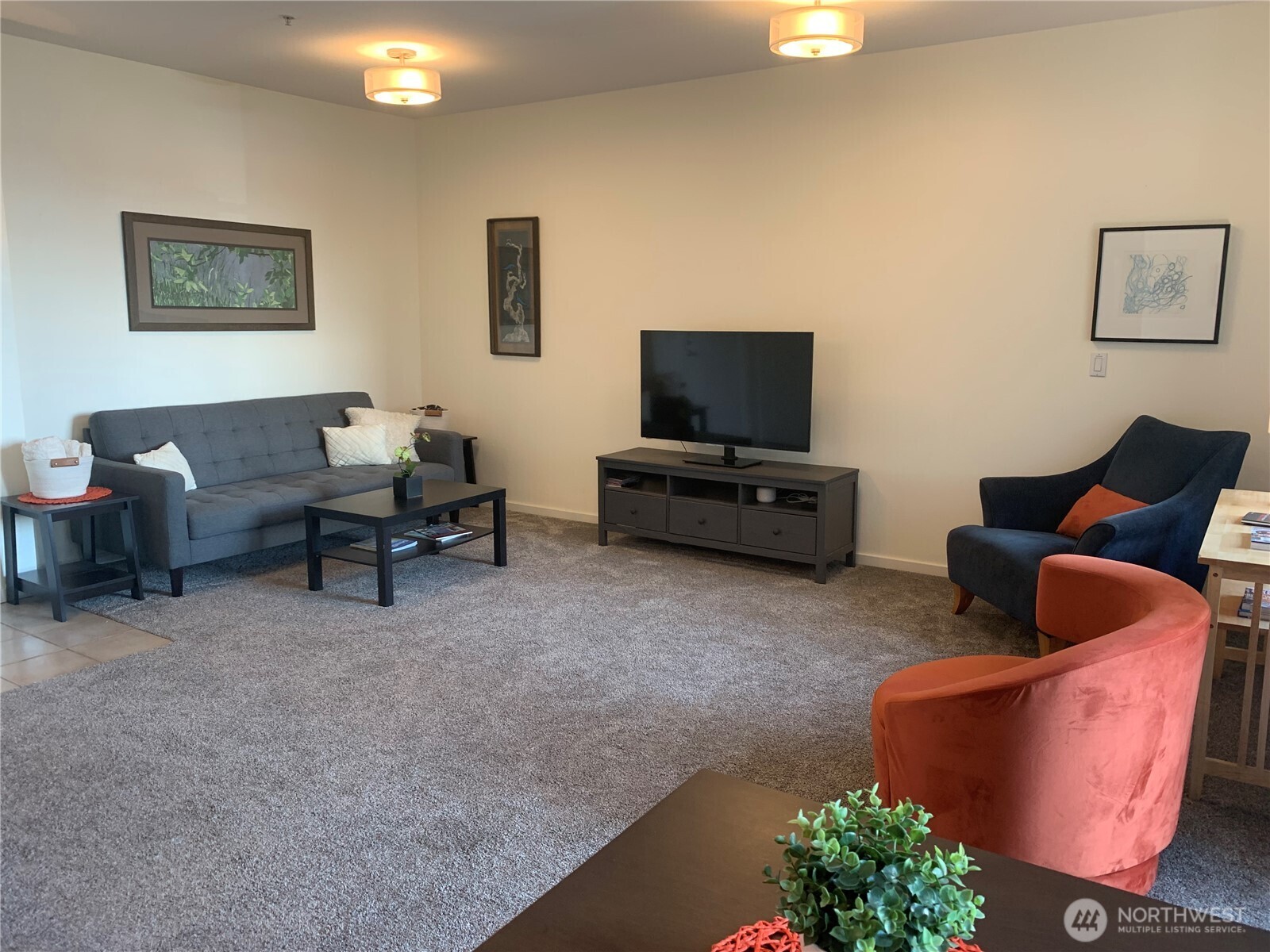2000 Alaskan Way, Unit 342 Seattle, WA 98121 - Photo 10 of 40 a living room with furniture and a flat screen tv