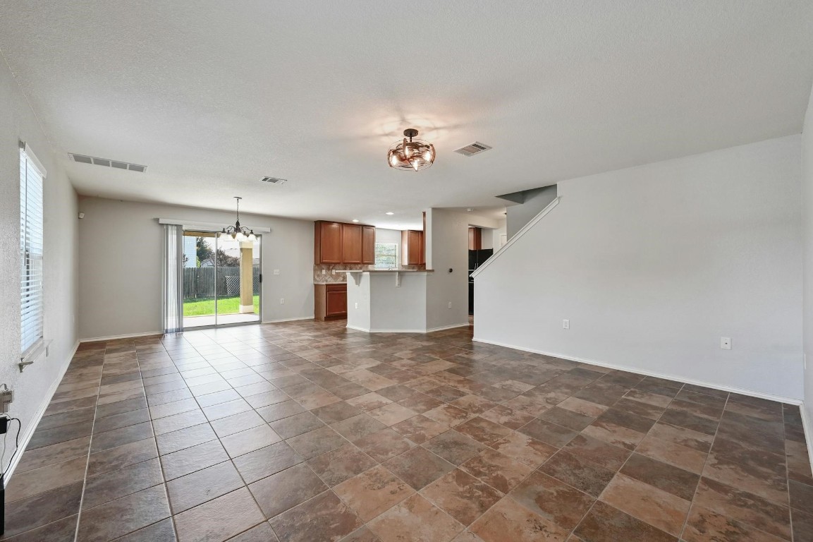 8901 Cornish Hen Cove Austin, TX 78747 - Photo 3 of 29 a view of a kitchen with furniture and wooden floor