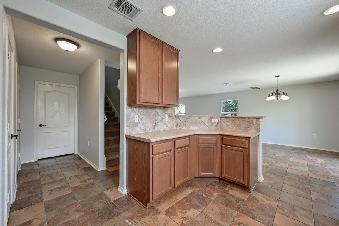 8901 Cornish Hen Cove Austin, TX 78747 - Photo 9 of 29 a kitchen with a sink cabinets and wooden floor