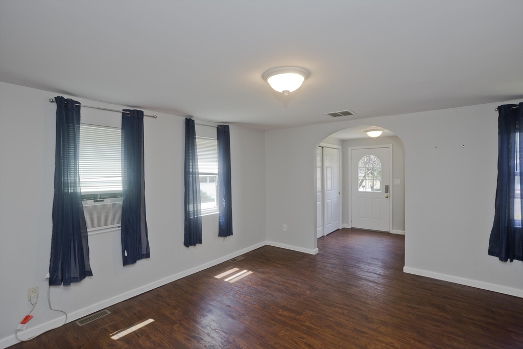 50 Cottage Road Enfield, CT 06082 - Photo 11 of 40 an empty room with wooden floor and windows