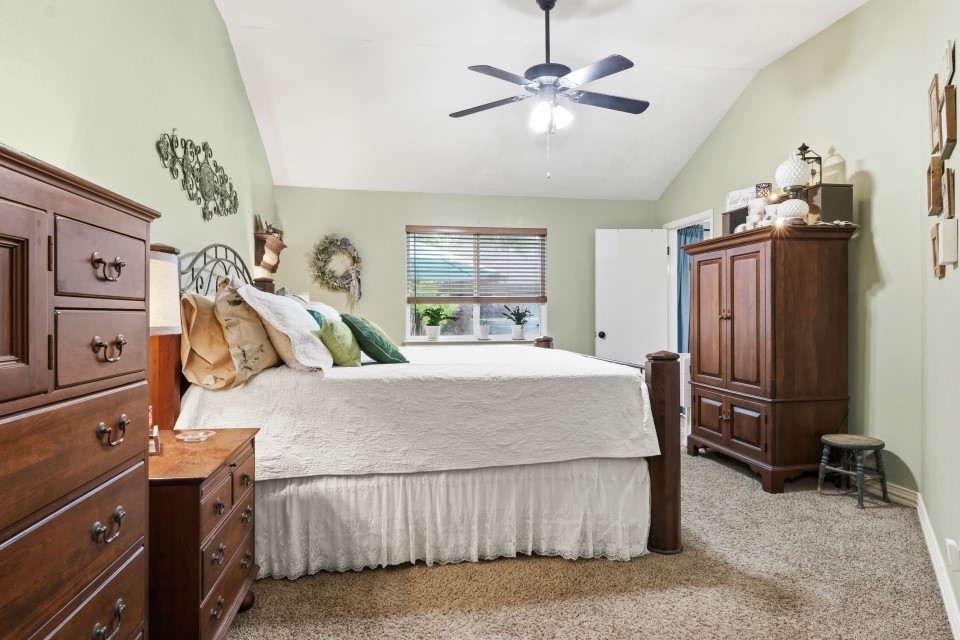 9211 Benwick Street Spring, TX 77379 - Photo 14 of 27 a bed room with a bed dresser and a flat tv screen