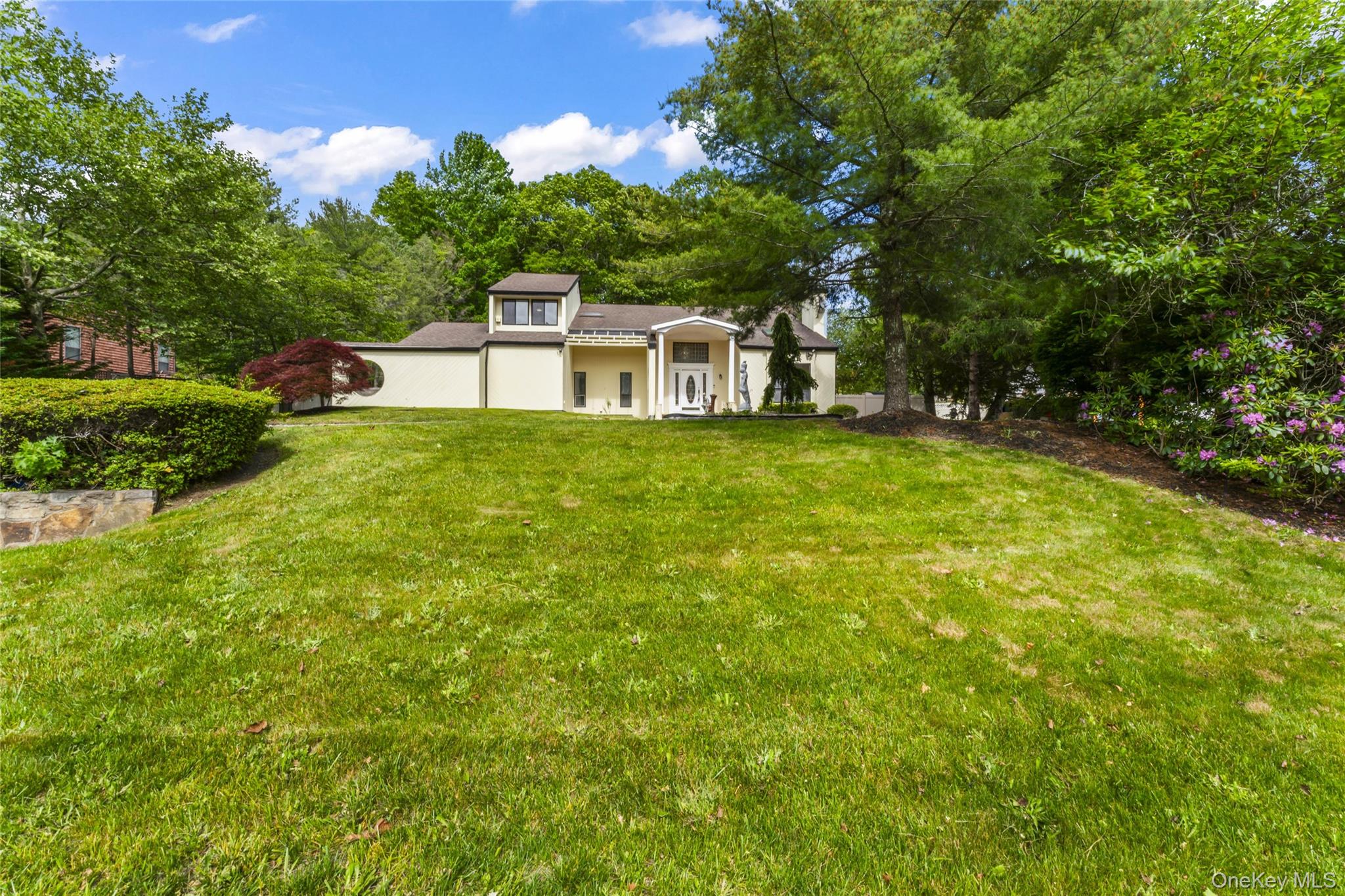 126 Bagatelle Road Melville, NY 11747 - Photo 49 of 50 a front view of a house with a yard