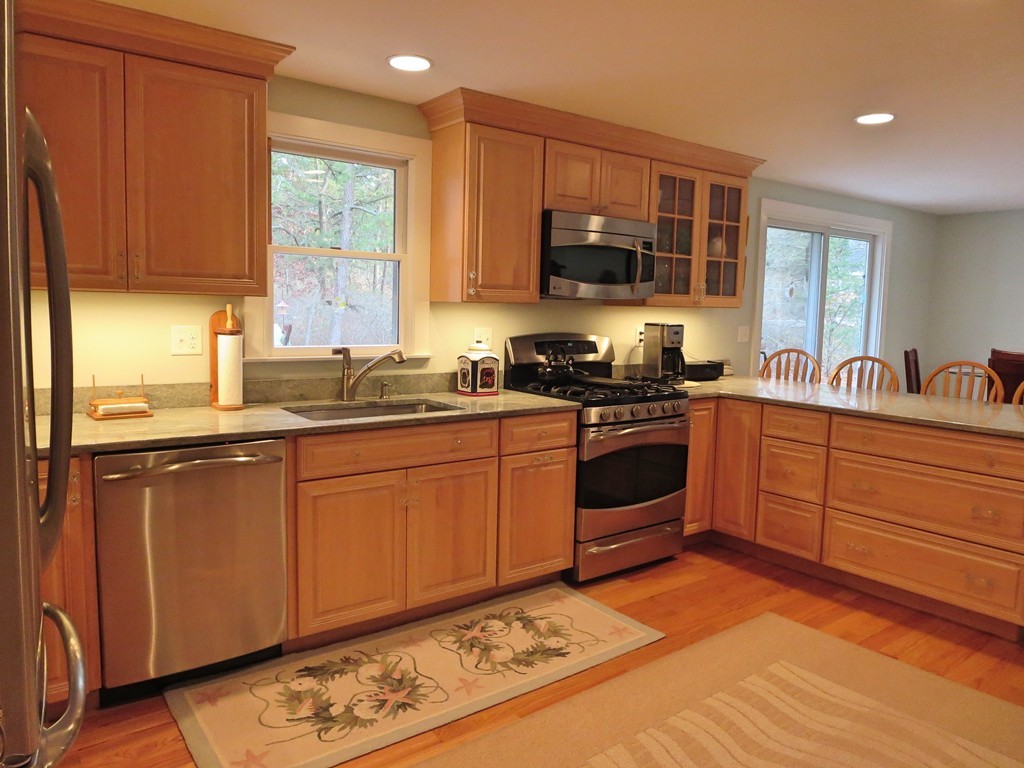 50 Wintergreen Road Mashpee, MA 02649 - Photo 3 of 30 a kitchen with stainless steel appliances granite countertop a stove a sink dishwasher and a microwave oven with cabinets