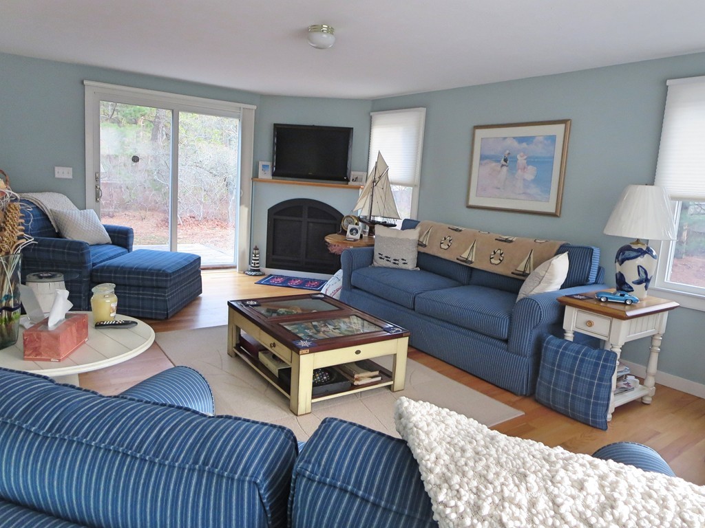 50 Wintergreen Road Mashpee, MA 02649 - Photo 10 of 30 a living room with furniture a fireplace and a flat screen tv