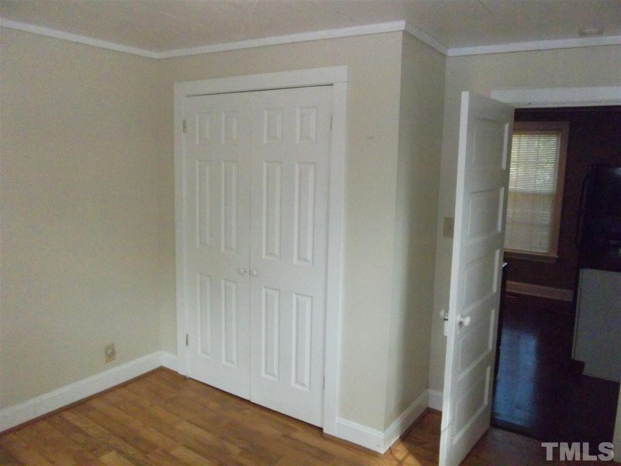1024 Stallings Road Durham, NC 27703 - Photo 12 of 18 an empty room with wooden floor
