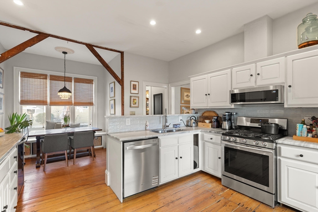16 Williams Street Salem, MA 01970 - Photo 11 of 29 a kitchen with stainless steel appliances granite countertop a stove and a sink
