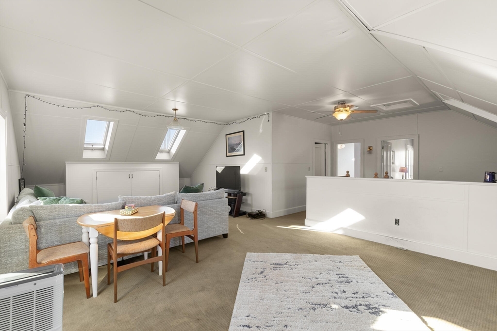 16 Williams Street Salem, MA 01970 - Photo 20 of 29 a living room with couches and kitchen view with wooden floor