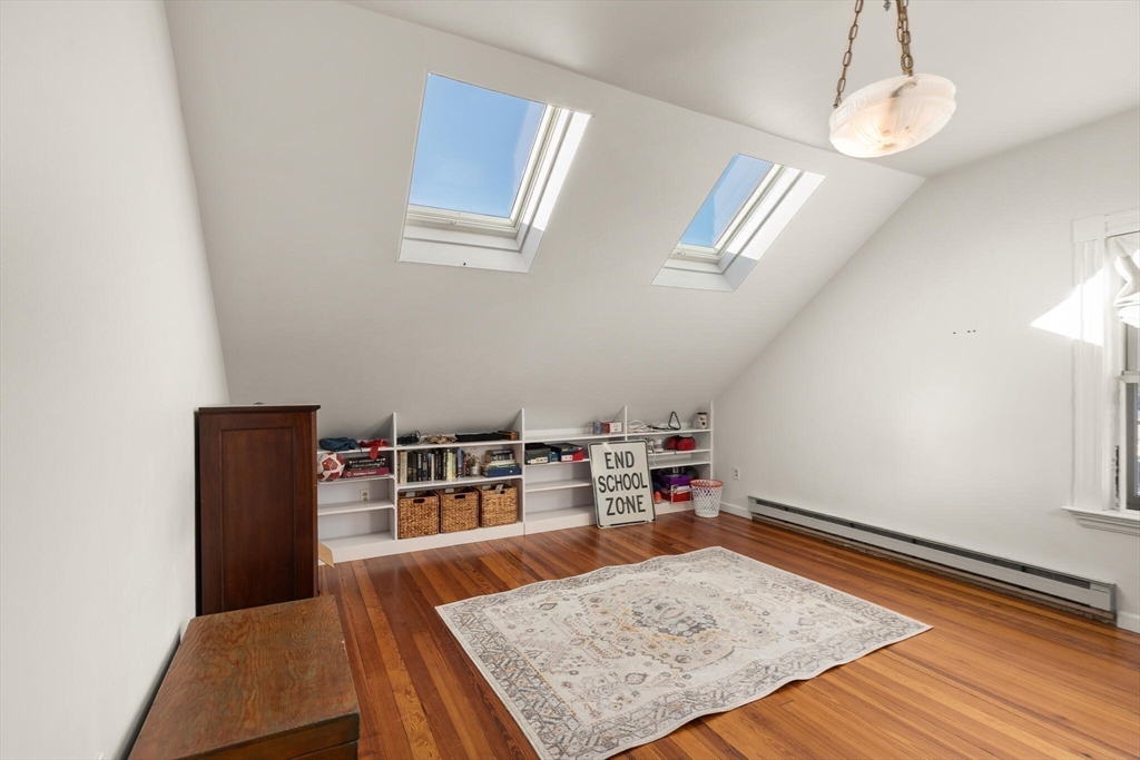 16 Williams Street Salem, MA 01970 - Photo 22 of 29 a bedroom with a bed and wooden floor