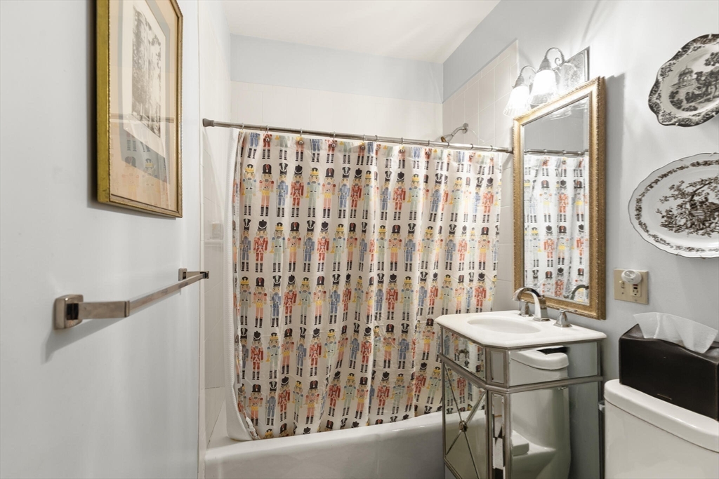 16 Williams Street Salem, MA 01970 - Photo 24 of 29 a bathroom with a sink a mirror and a shower curtain