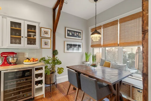 a view of a dining room with furniture a chandelier and wooden floor
