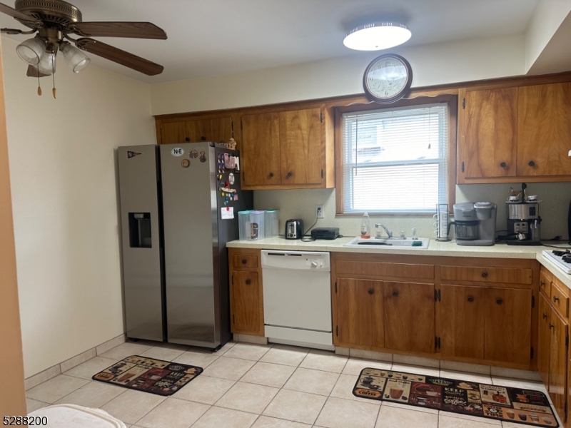 a kitchen with a refrigerator a sink and cabinets
